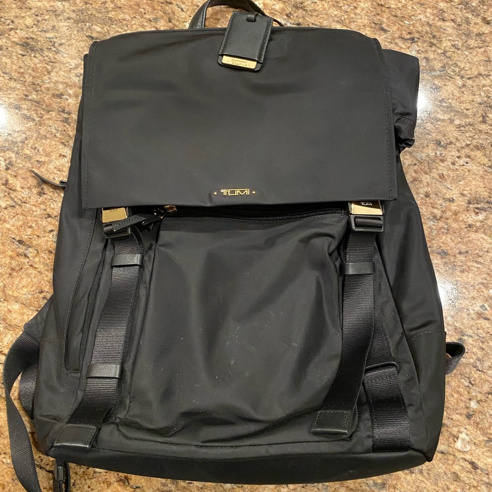 Tumi women work backpack with laptop section. Gold metal, vinyl material